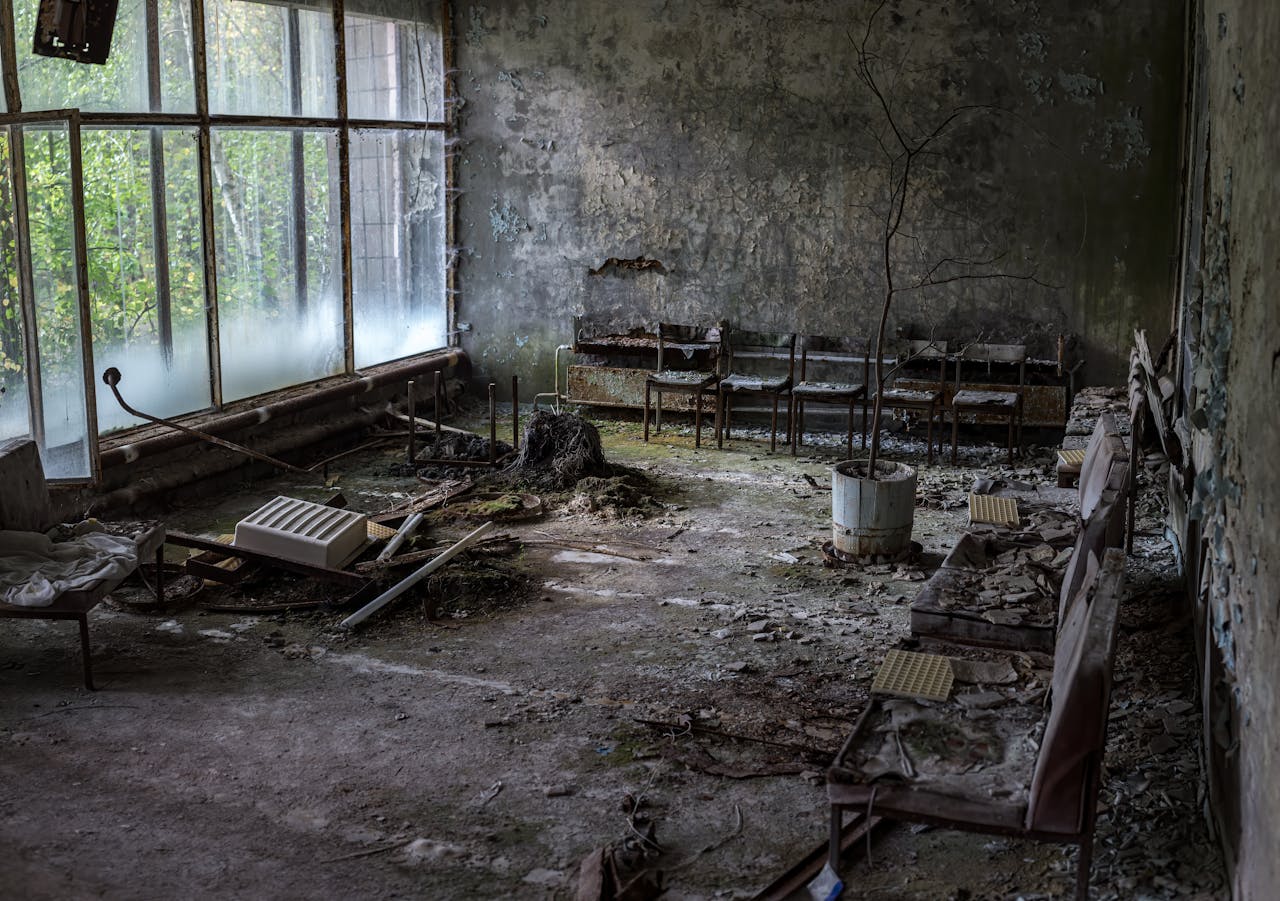 Desolate room in Prypyat, Ukraine, showcasing decay and nature reclaiming space.